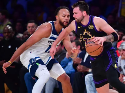 Mar 10, 2026; Los Angeles, California, USA; Los Angeles Lakers guard Luka Doncic (77) moves the ball against Minnesota Timberwolves forward Kyle Anderson (12) during the second half at Crypto.com Arena. Mandatory Credit: Gary A. Vasquez-Imagn Images