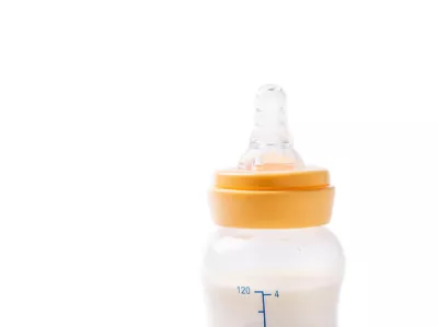 Milk bottle for baby feeding and dummy isolated on white background