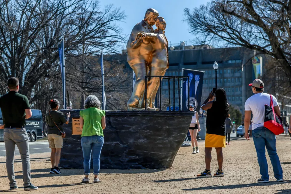 People look at a statue depicting U.S. President Donald Trump and convicted sex offender Jeffrey Epstein, entitled "The King of the World", on the National Mall in Washington, D.C., U.S., March 10, 2026. REUTERS/Evelyn Hockstein