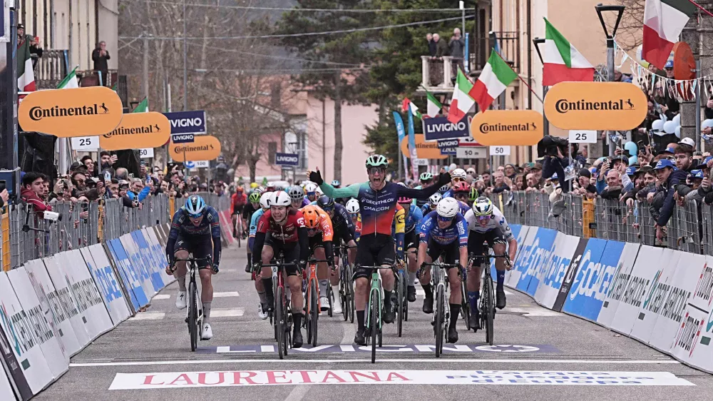 Denmark's Tobias Lund Andresen celebrates as he crosse the finish line to win the third stage of the Tirreno-Adriatico cycling race from Cortona to Magliano de' Marsi, Italy, Wednesday, March 11, 2026. (Marco Alpozzi/LaPresse via AP)