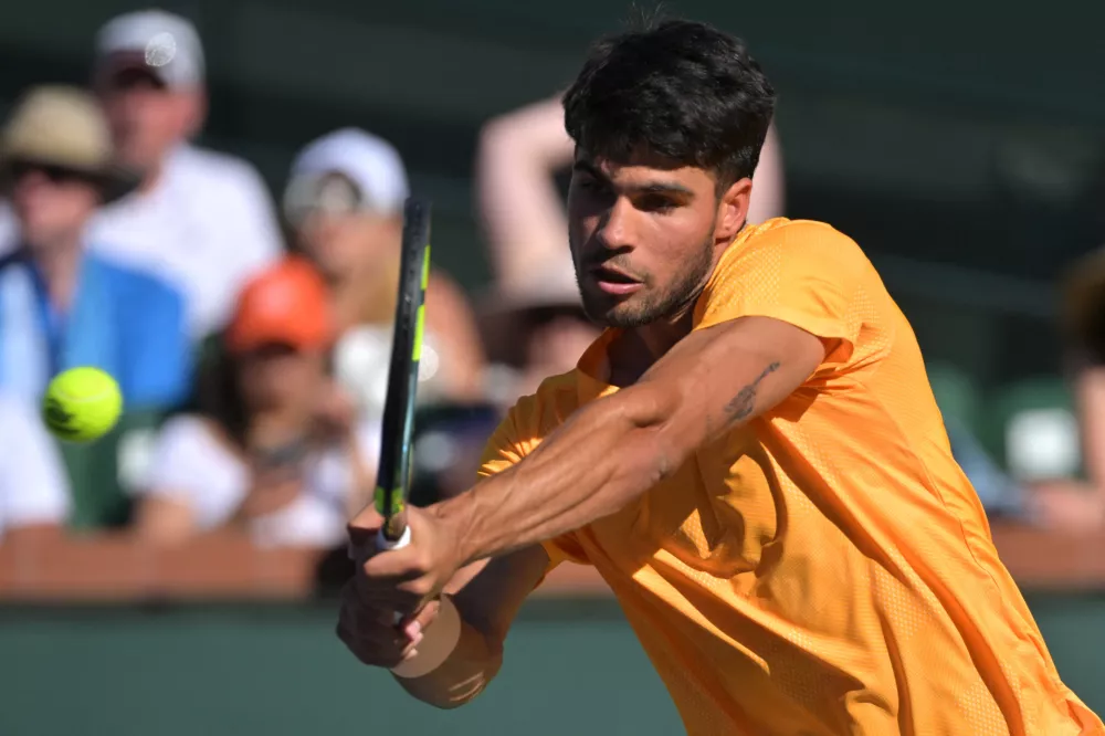Mar 11, 2026; Indian Wells, CA, USA; Carlos Alcaraz (ESP) hits a shot as he defeated Casper Ruud (NOR) during the fourth round in the BNP Paribas Open at the Indian Wells Tennis Garden. Mandatory Credit: Jayne Kamin-Oncea-Imagn Images