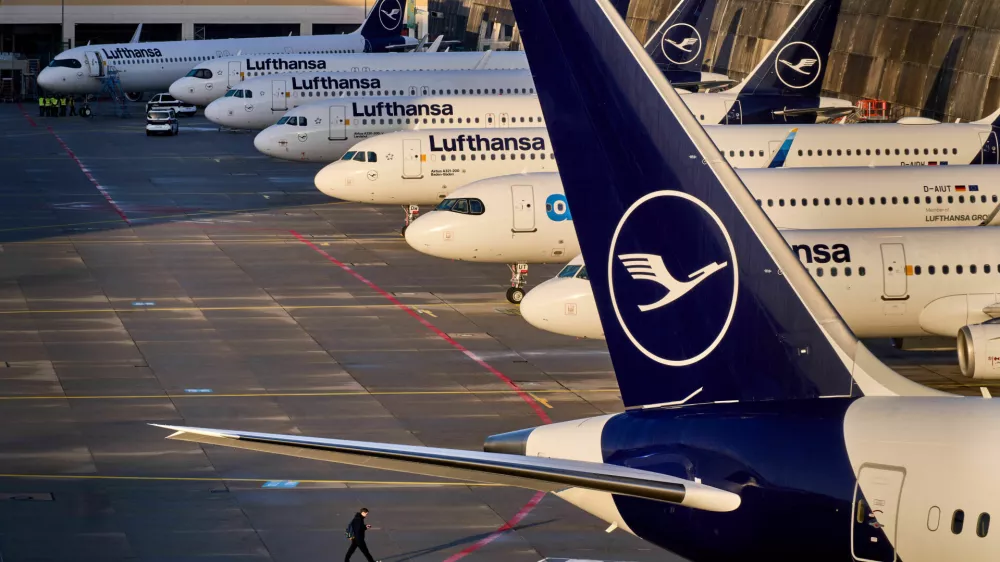 A man walks past parked Lufthansa aircraft at the airport as Lufthansa pilots are on a two-day strike, in Frankfurt, Germany, Thursday, March 12, 2026. (AP Photo/Michael Probst)