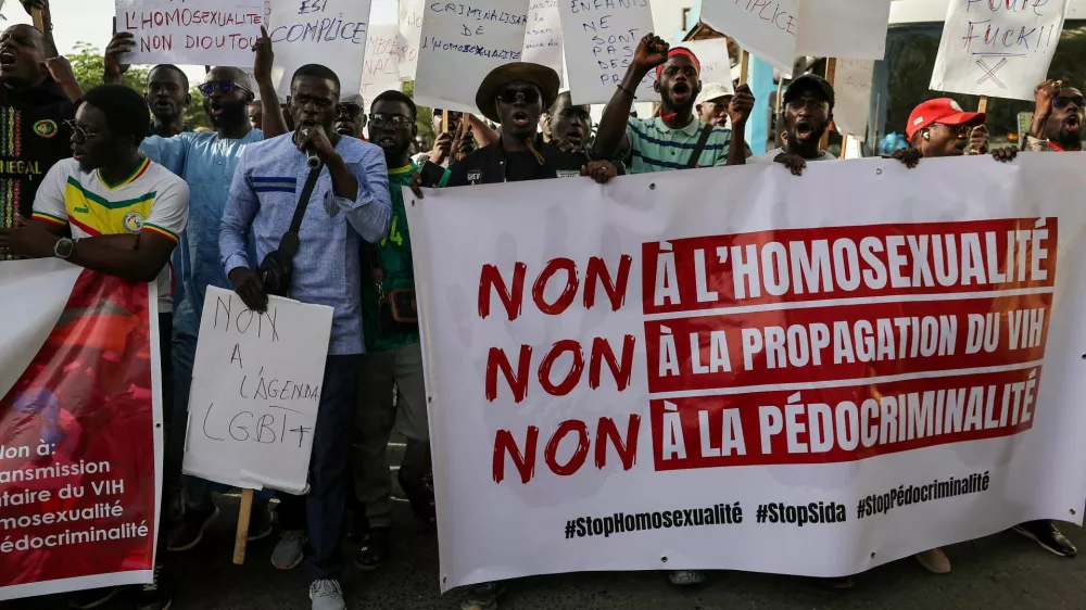 FILE PHOTO: SENSITIVE MATERIAL. THIS IMAGE MAY OFFEND OR DISTURB. Anti‑LGBT supporters march through the streets during a protest calling for tougher action after authorities detained people for what police said were crimes including same‑sex intercourse and intentional HIV transmission, and about a dozen others in what police said was a child‑abuse network, in Dakar, Senegal, February 14, 2026. REUTERS/Zohra Bensemra/File Photo