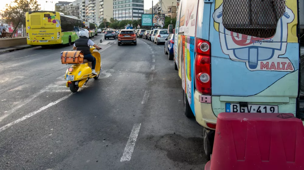 Valletta, Malta Nov 2, 2024 A yellow scooter on the main coastal road in the Sliema district.