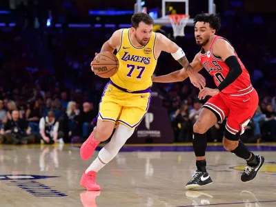 Mar 12, 2026; Los Angeles, California, USA; Los Angeles Lakers guard Luka Doncic (77) moves the ball against Chicago Bulls guard Tre Jones (30) during the first half at Crypto.com Arena. Mandatory Credit: Gary A. Vasquez-Imagn Images