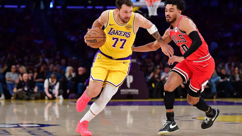 Mar 12, 2026; Los Angeles, California, USA; Los Angeles Lakers guard Luka Doncic (77) moves the ball against Chicago Bulls guard Tre Jones (30) during the first half at Crypto.com Arena. Mandatory Credit: Gary A. Vasquez-Imagn Images
