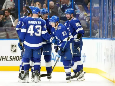 Tampa Bay Lightning center Brayden Point (21) celebrates his goal against the Detroit Red Wings with right wing Nikita Kucherov (86) and defenseman Darren Raddysh (43) during the third period of an NHL hockey game Thursday, March 12, 2026, at Benchmark International Arena in Tampa, Fla. (AP Photo/Chris O'Meara)