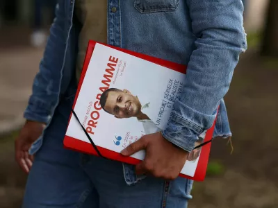Municipal candidate Sofiane Milous, running on a green ticket in France's upcoming local elections and campaigning against a data centre, holds leaflets as he goes door to door to speak to voters in Le Bourget, north of Paris, France, March 11, 2026. REUTERS/Abdul?Saboor