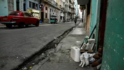 A man and his cat sit at the door of their home as Cuba's President Miguel Diaz-Canel announces on state television that the country has opened talks with the U.S. government amid a severe economic crisis and as the Communist government has come under increasing pressure from U.S. President Donald Trump, in Havana, Cuba, March 13, 2026. REUTERS/Norlys Perez   TPX IMAGES OF THE DAY