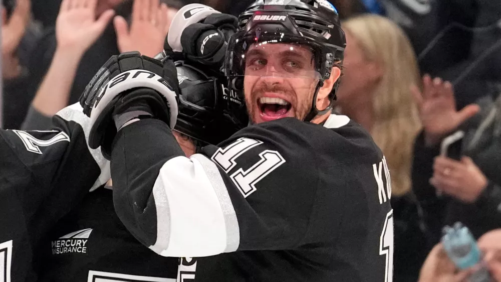 Los Angeles Kings defenseman Mikey Anderson, left, celebrates his goal with center Anze Kopitar during the second period of an NHL hockey game against the New York Islanders, Thursday, March 5, 2026, in Los Angeles. (AP Photo/Mark J. Terrill)