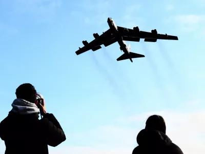 A plane spotter takes pictures as a U.S. Air Force Boeing B-52 Stratofortress takes off at RAF Fairford airbase, used by United States Air Force (USAF) personnel, amid the U.S.&ndash;Israeli conflict with Iran, in Fairford, Gloucestershire, Britain, March 15, 2026. REUTERS/Jack Taylo