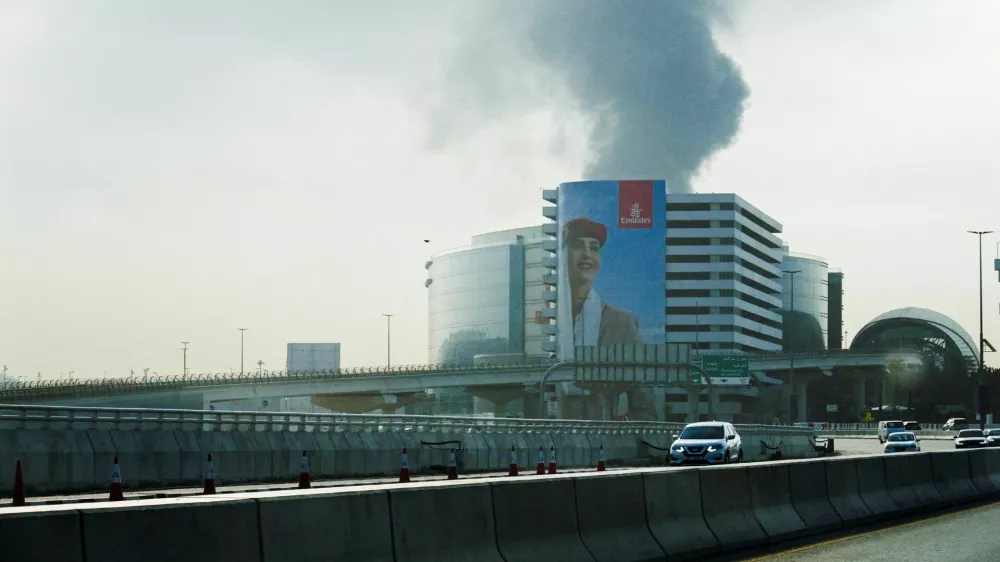 Smoke rising from the Dubai International Airport is seen through the windshield of a vehicle, after a drone attack hit a fuel tank, according to Dubai authorities, amid the U.S.-Israel conflict with Iran, in Dubai, United Arab Emirates, March 16, 2026, REUTERS/Stringer REFILE - QUALITY REPEAT