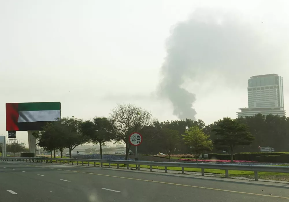 Smoke rising from the Dubai International Airport is seen through the windshield of a vehicle, after a drone attack hit a fuel tank, according to Dubai authorities, amid the U.S.-Israel conflict with Iran, in Dubai, United Arab Emirates, March 16, 2026, REUTERS/Stringer
