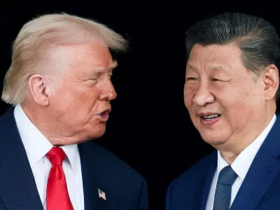 FILE PHOTO: U.S. President Donald Trump and Chinese President Xi Jinping talk as they leave after a bilateral meeting at Gimhae International Airport, on the sidelines of the Asia-Pacific Economic Cooperation (APEC) summit, in Busan, South Korea, October 30, 2025. REUTERS/Evelyn Hockstein/File Photo