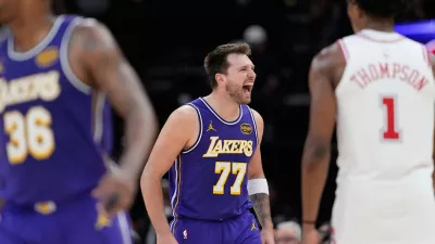 Los Angeles Lakers' Luka Doncic (77) celebrates after making a basket against the Houston Rockets during the second half of an NBA basketball game Wednesday, March 18, 2026, in Houston. (AP Photo/David J. Phillip)