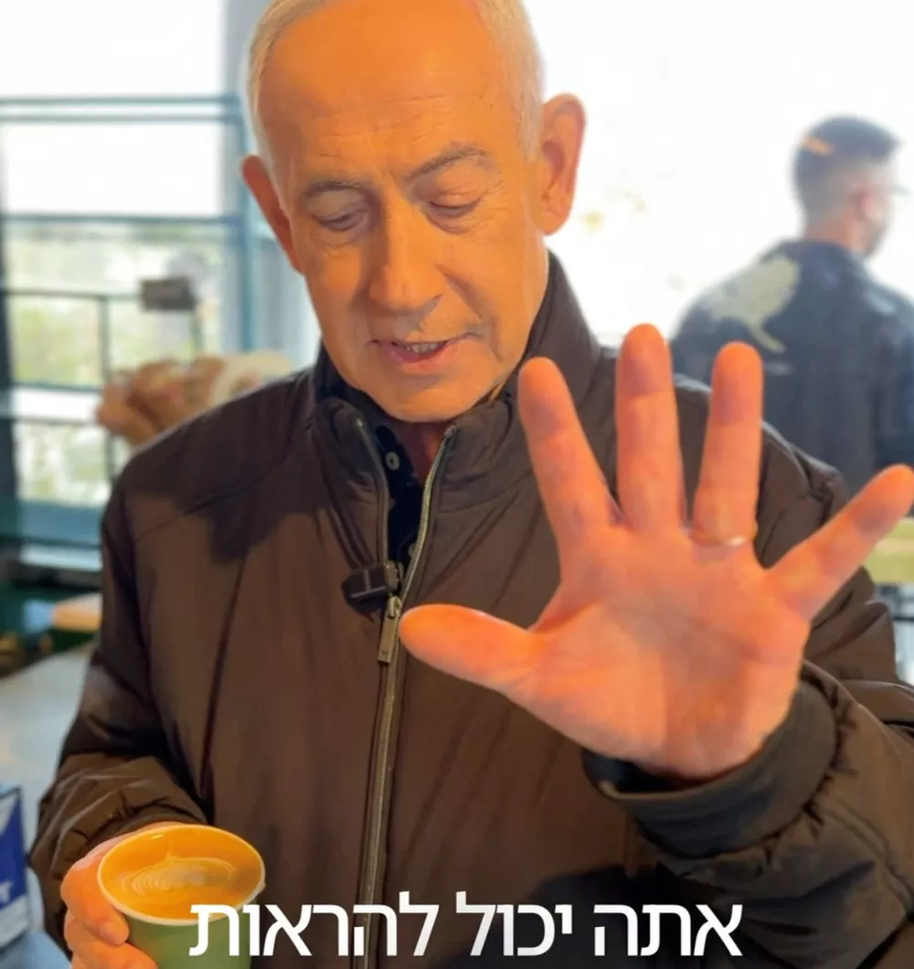 Israeli Prime Minister Benjamin Netanyahu shows his hand as he speaks at a cafe, amid the U.S.-Israeli conflict with Iran, in Jerusalem, March 15, 2026, in this screen grab taken from a handout video. Benjamin Netanyahu via Telegram/Handout via REUTERS  THIS IMAGE HAS BEEN SUPPLIED BY A THIRD PARTY. NO RESALES. NO ARCHIVES. MANDATORY CREDIT. TEXT OVERLAY FROM SOURCE. VERIFICATION: - Cafe interiors matched file imagery of the area. - Date verified by multiple corroborating videos and photos posted by the cafe on March 15. - No older versions of the video were found posted online before March 15. - Coordinates: 31.775368725805468, 35.12722970081208