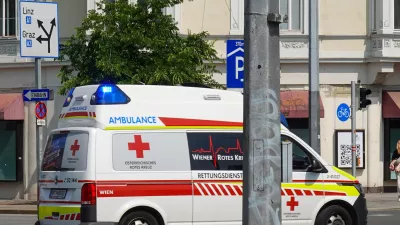 An ambulance of the Wiener Rotes Kreuz (Vienna Red Cross) drives with flashing blue lights through an intersection in Vienna, Austria, on June 10, 2025. The emergency vehicle belongs to the Austrian Red Cross and is part of the city's health and rescue services. (Photo by Michael Nguyen/NurPhoto)NO USE FRANCE