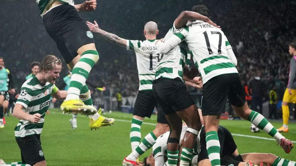 Sporting CP players celebrate after Sporting's Maximiliano Araujo scored his side's fourth goal during a Champions League round of 16 second leg soccer match between Sporting CP and Bodo Glimt in Lisbon, Portugal, Tuesday, March 17, 2026. (AP Photo/Ana Brigida)
