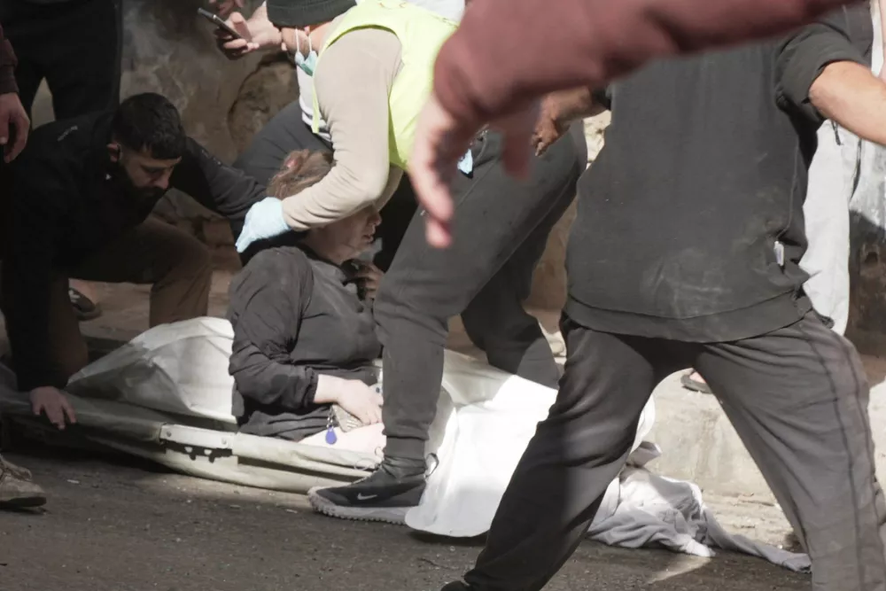 Paramedics and civilians help an injured woman following an Israeli air strike in Beirut, following an escalation between Hezbollah and Israel amid the U.S.-Israeli conflict with Iran, Lebanon, March 18, 2026. REUTERS/Stringer