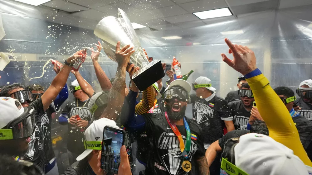 The Venezuela team celebrate with the trophy after defeating the United States in the championship game of the World Baseball Classic, Tuesday, March 17, 2026, in Miami. (AP Photo/Rebecca Blackwell)