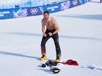 Austria's Benjamin Karl celebrates winning the gold medal in the men's snowboarding parallel giant slalom finals at the 2026 Winter Olympics, in Livigno, Italy, Sunday, Feb. 8, 2026. (AP Photo/Lindsey Wasson)
