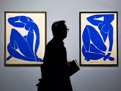 A man walks past the paintings "Blue Nude II, 1952" and "Blue Nude III, 1952" by painter Henri Matisse (1869-1954) during a press visit of the exhibition "Matisse, 1941 - 1954" at the Grand Palais in Paris, France, March 23, 2026. REUTERS/Sarah Meyssonnier