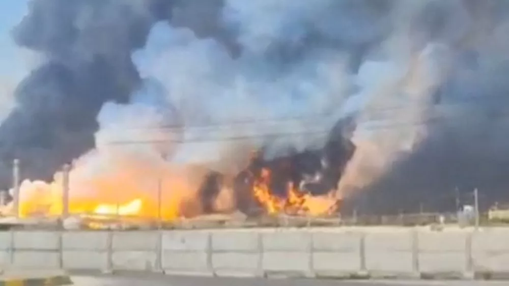 Smoke and fire rise near the South Pars gas field following an attack, amid the U.S.-Israeli conflict with Iran, in Bushehr Province, Iran, March 18, 2026, in this screengrab obtained from a social media video. Social Media/via REUTERS THIS IMAGE HAS BEEN SUPPLIED BY A THIRD PARTY. NO RESALES. NO ARCHIVES. NEWS ONLY USE.  VERIFICATION: Reuters confirmed the location from the road layout, light house, electric pylons, and ship model. Reuters could not confirm the date of footage, however Iran's Fars news agency reported that gas tanks and parts of a refinery had been hit and state media later said the fire there was under control. No older versions of the video were found before March 18. Coordinates of the structures under fire was seen from 27.525170402738087, 52.572015374827416. NASA FIRMS detected thermal activity in the vicinity on March 18.  Iranian gas flows to Iraq were halted on Wednesday following an attack on Iran's Pars gas field, a senior Iraqi official told Reuters.