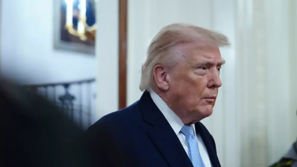 President Donald Trump arriving to speak at the Commander-in-Chief's Trophy presentation with the Navy Midshipmen football team in the East Room of the White House, Friday, March 20, 2026, in Washington. (AP Photo/Julia Demaree Nikhinson)