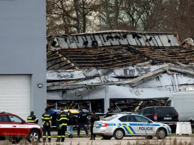 Police officers and a firefighters stand in front of a burned production hall at an industrial area in Pardubice, Czech Republic, March 20, 2026. REUTERS/David W Cerny   TPX IMAGES OF THE DAY