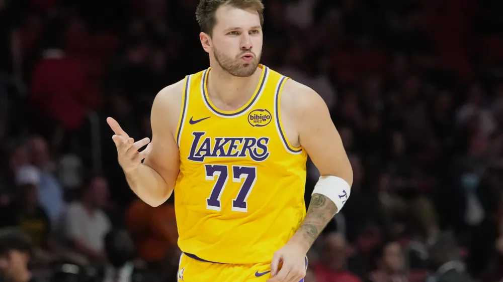 Los Angeles Lakers guard Luka Doncic (77) reacts after scoring during the second half of an NBA basketball game against the Miami Heat, Thursday, March 19, 2026, in Miami. (AP Photo/Lynne Sladky)