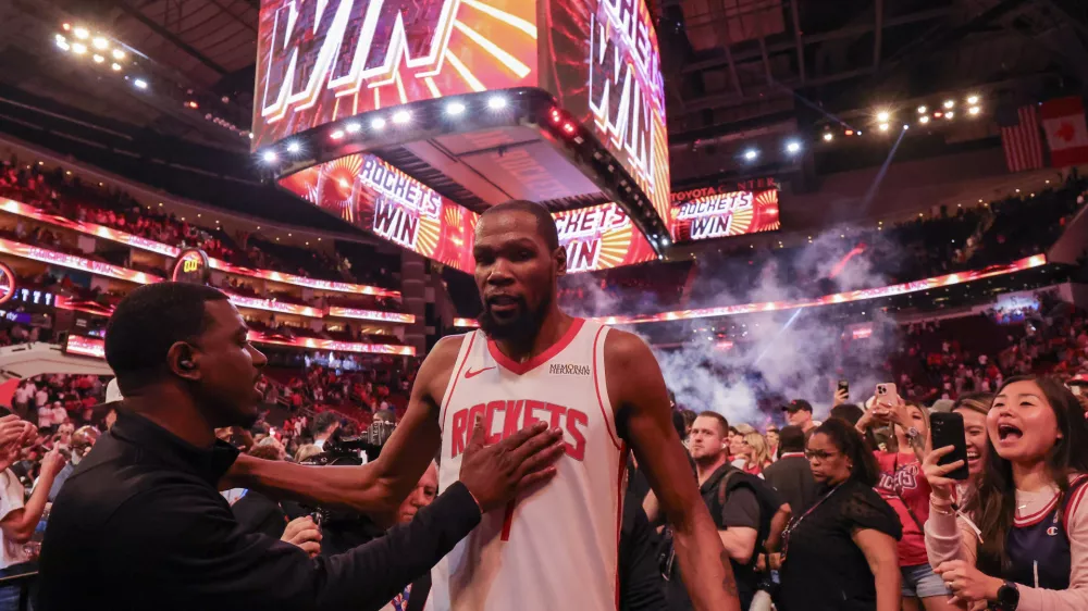 Mar 21, 2026; Houston, Texas, USA; A fan pats Houston Rockets forward Kevin Durant (7) on the chest after the game against the Miami Heat at Toyota Center. Mandatory Credit: Thomas Shea-Imagn Images