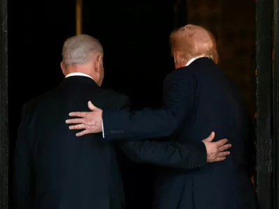 FILE PHOTO: U.S. President Donald Trump and Israeli Prime Minister Benjamin Netanyahu embrace as they walk into Trump's Mar-a-Lago club in Palm Beach, Florida, U.S., December 29, 2025. REUTERS/Jonathan Ernst/File Photo