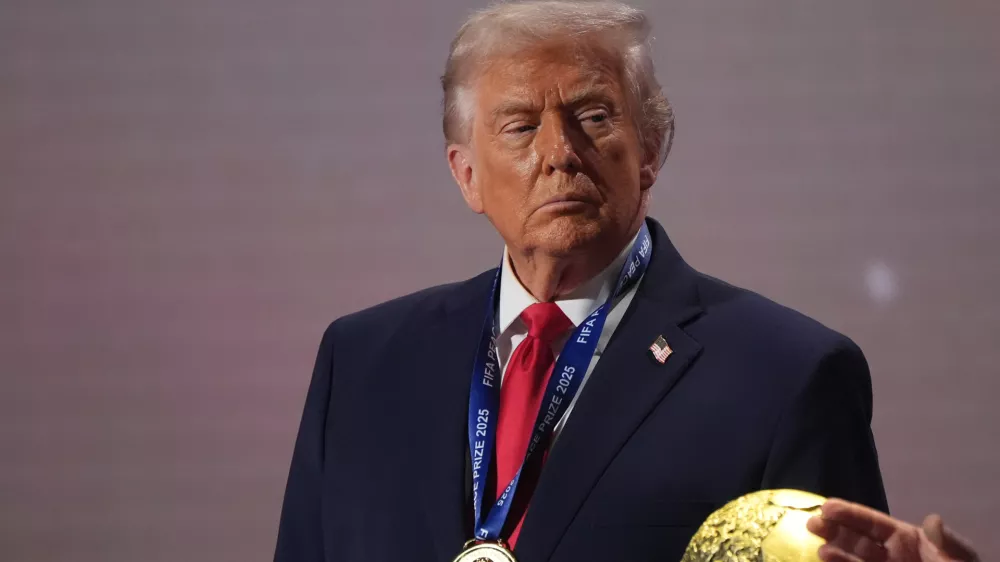 FILE - President Donald Trump stands on stage next to the FIFA World Cup after receiving the FIFA Peace Prize during the draw for the 2026 soccer World Cup at the Kennedy Center in Washington, Dec. 5, 2025. (AP Photo/Jacquelyn Martin, File)