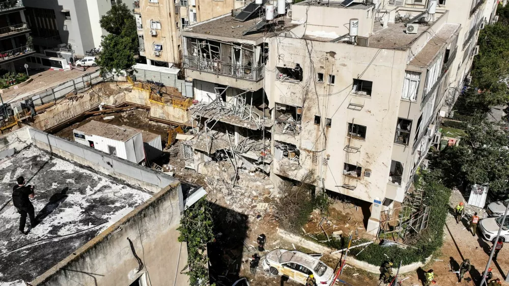 A drone view of emergency personnel working at a site following Iranian missile barrages in central Israel, amid the U.S.-Israel conflict with Iran, in Tel Aviv, Israel, March 24, 2026. REUTERS/Roei Kastro
