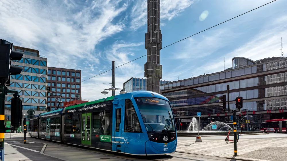 Stockholm, Sweden - May 06, 2024: Tram passing in front of the glass sculpture called Kristallvertikalaccent on Sergel Square with Kulturhuset in the background