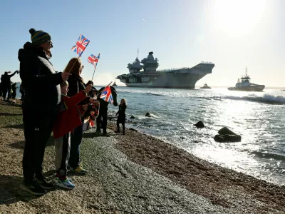 People gather to watch HMS Prince of Wales return home to Portsmouth, following an eight-month Indo-Pacific deployment as part of Operation Highmast, in Portsmouth, Britain November 30, 2025. UK MOD Crown/Ollie Leach/Handout via REUTERS THIS IMAGE HAS BEEN SUPPLIED BY A THIRD PARTY