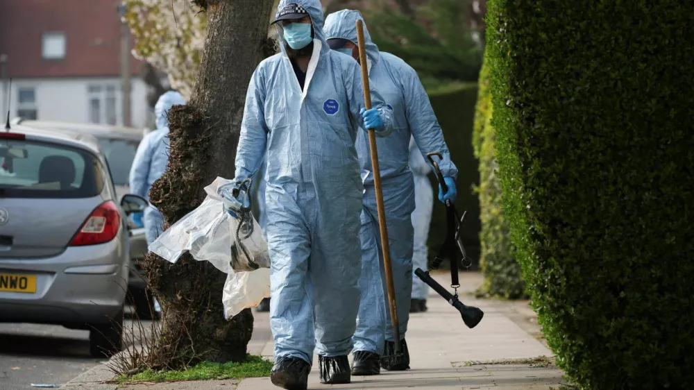 Forensic officers inspect the area at a street near the scene where four ambulances belonging to Hatzola, a Jewish community organisation, were set on fire in an incident that the police say is being treated as an antisemitic hate crime, in northwest London, Britain, March 23, 2026. REUTERS/Isabel Infantes
