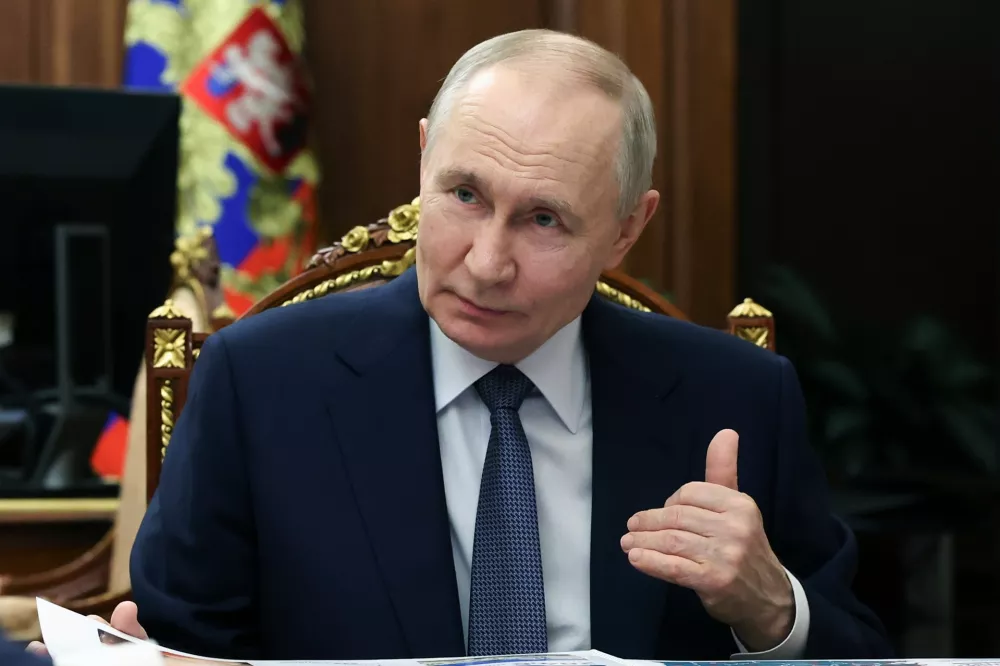 Russian President Vladimir Putin speaks to Kaliningrad Region Governor Alexei Besprozvannykh during their meeting at the Kremlin in Moscow, Tuesday, March 24, 2026. (Gavriil Grigorov/Sputnik, Kremlin Pool Photo via AP)