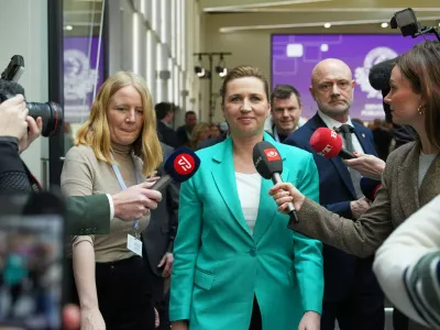Chairman of the Social Democrats Mette Frederiksen leaves after a party leaders debate the day after the parliamentary election at the Confederation of Danish Industry's building in Copenhagen, Wednesday, March 25, 2026. (AP Photo/Sergei Grits)