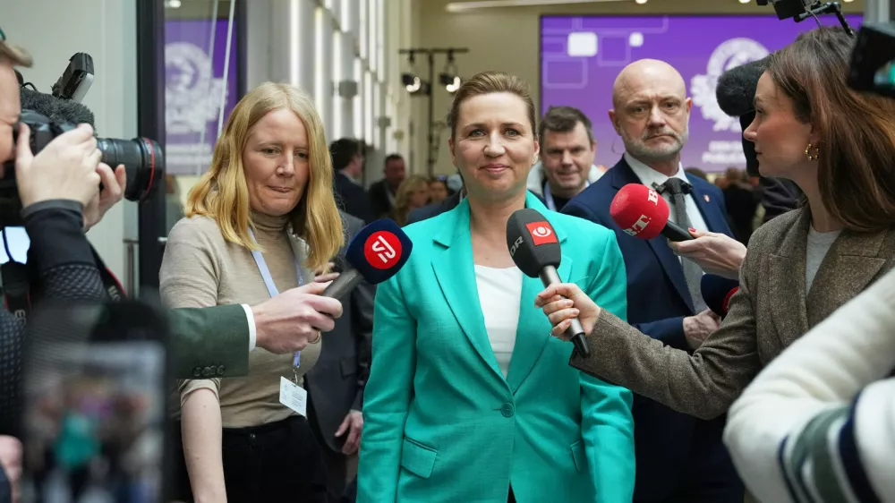 Chairman of the Social Democrats Mette Frederiksen leaves after a party leaders debate the day after the parliamentary election at the Confederation of Danish Industry's building in Copenhagen, Wednesday, March 25, 2026. (AP Photo/Sergei Grits)
