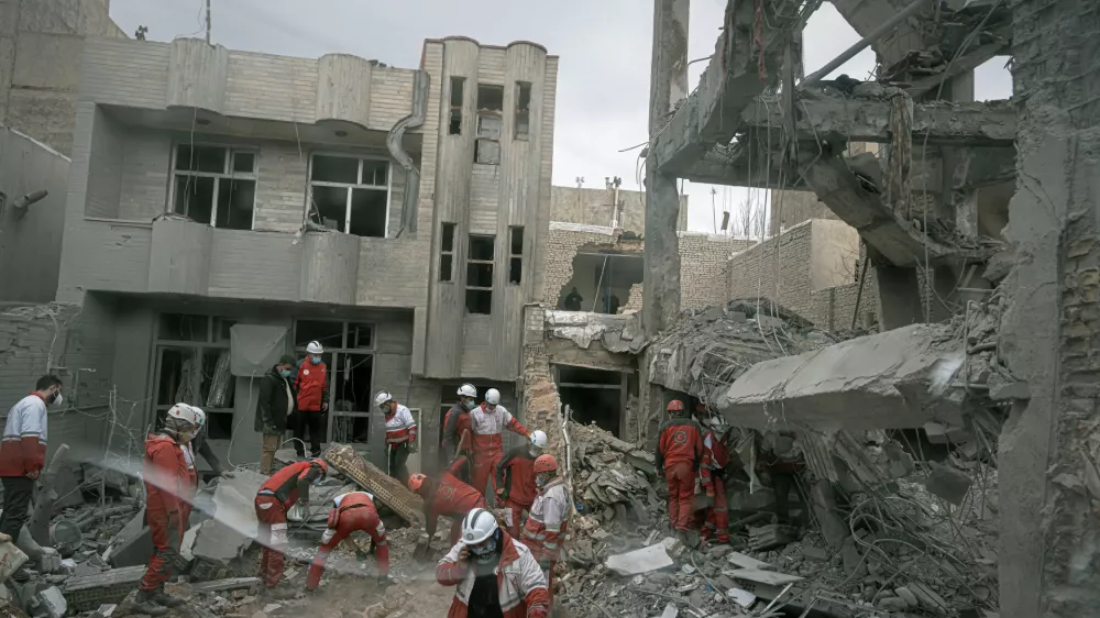 FILE - First responders inspect the remains of a residential building hit in an overnight strike during the U.S.-Israeli military campaign in Tabriz, Iran, March 24, 2026. (AP Photo/Matin Hashemi, File)