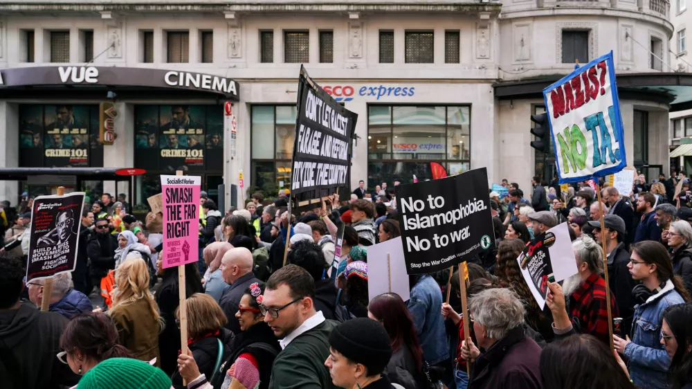 People hold placards and banners during the "Together Against the Far Right" demonstration, in London, Saturday, March 28, 2026.(AP Photo/Alberto Pezzali)