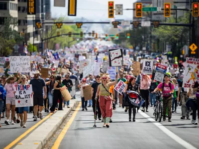 People take part in a "No Kings" protest where they marched from Washington Square Park to the Capitol in Salt Lake City on Saturday, March 28, 2026. (Tess Crowley/The Deseret News via AP)