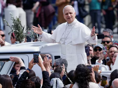Pope Leo XIV gestures as he leaves after Palm Sunday Mass in Saint Peter's Square at the Vatican, March 29, 2026. REUTERS/Remo Casilli