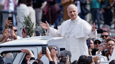 Pope Leo XIV gestures as he leaves after Palm Sunday Mass in Saint Peter's Square at the Vatican, March 29, 2026. REUTERS/Remo Casilli