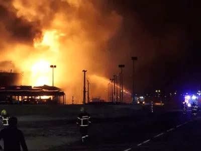 Firefighters work at the site after reported Iranian strikes triggered fire at fuel tanks near the airport, in Muharraq, Bahrain March 12, 2026, in this screengrab taken from a handout video.  Bahrain Information Ministry/Handout via REUTERS  THIS IMAGE HAS BEEN SUPPLIED BY A THIRD PARTY. VERIFICATION: - Tanks, utility poles and buildings matched file and satellite imagery - Coordinates of the facility on fire: 26.26282799860747, 50.65329169205331 - Exact time not verified but no older version of the video was found posted online before March 12 - Bahrain's Ministry of Interior wrote on X that fuel tanks at a facility in Muharraq were targeted by Iranian forces on the morning of March 12
