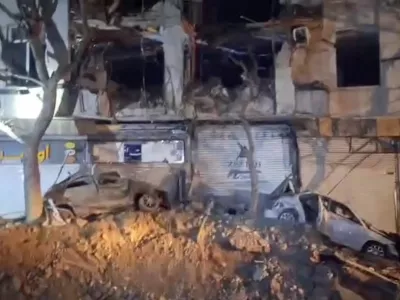 Damage to a building and vehicles in the aftermath of a reported strike, amid the U.S.-Israeli conflict with Iran, in Tehran, Iran, March 28, 2026, in this screengrab from video.  Iranian Red Crescent Society/Handout via REUTERS  THIS IMAGE HAS BEEN SUPPLIED BY A THIRD PARTY. MANDATORY CREDIT. NO RESALES. NO ARCHIVES  VERIFICATION Buildings, business signs and structure matched the file and satellite imagery of the area Date not verified Iranian Red Crescent Society and corroborating reports from Iranian media confirmed the damage on March 28 No old results were found posted online before March 28