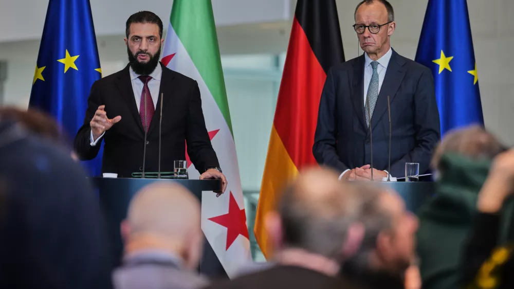 German Chancellor Friedrich Merz, right, and Syrian President Ahmad al-Sharaa attend a press conference in Berlin, Germany, Monday, March 30, 2026. (AP Photo/Markus Schreiber)