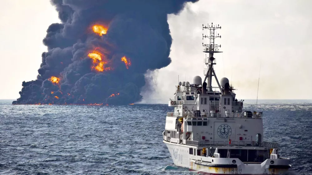In this Sunday, Jan. 14, 2018, photo provided by China's Ministry of Transport, a rescue ship sails near the burning Iranian oil tanker Sanchi in the East China Sea off the eastern coast of China. The fire from the sunken Iranian tanker ship in the East China Sea has burned out, a Chinese transport ministry spokesman said Monday, although concerns remain about possible major pollution to the sea bed and surrounding waters. (Ministry of Transport via AP)