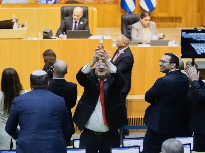Israel's Minister of National Security, Itamar Ben-Gvir, center, and lawmakers celebrate after Israel's parliament passed a law approving the death penalty for Palestinians convicted of murdering Israelis, at the Knesset in Jerusalem Monday, March 30, 2026. (AP Photo/Itay Cohen)